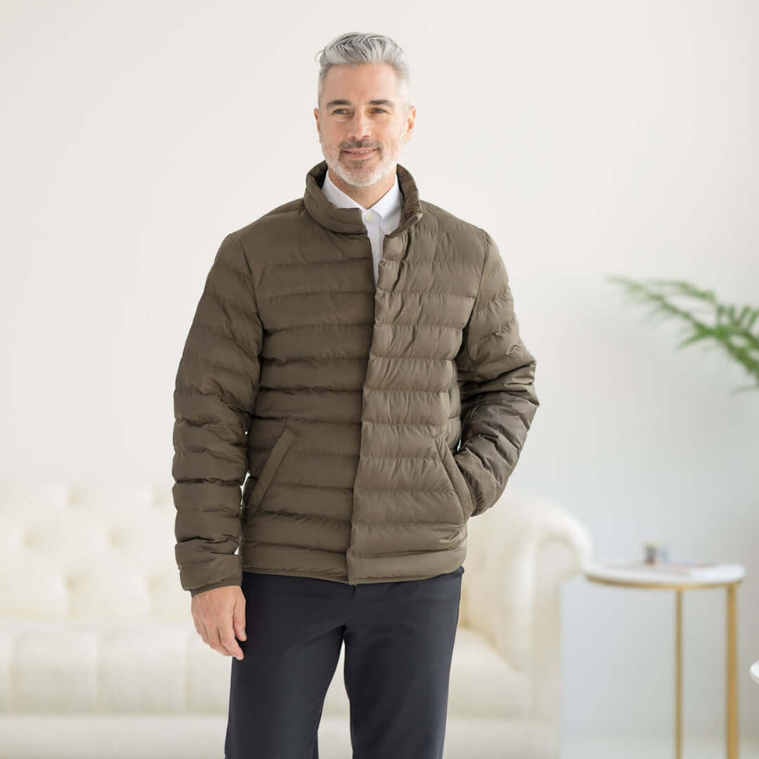 Olive Weatherproof x MagnaReady magnetic front water-resistant puffer jacket on a smiling model.