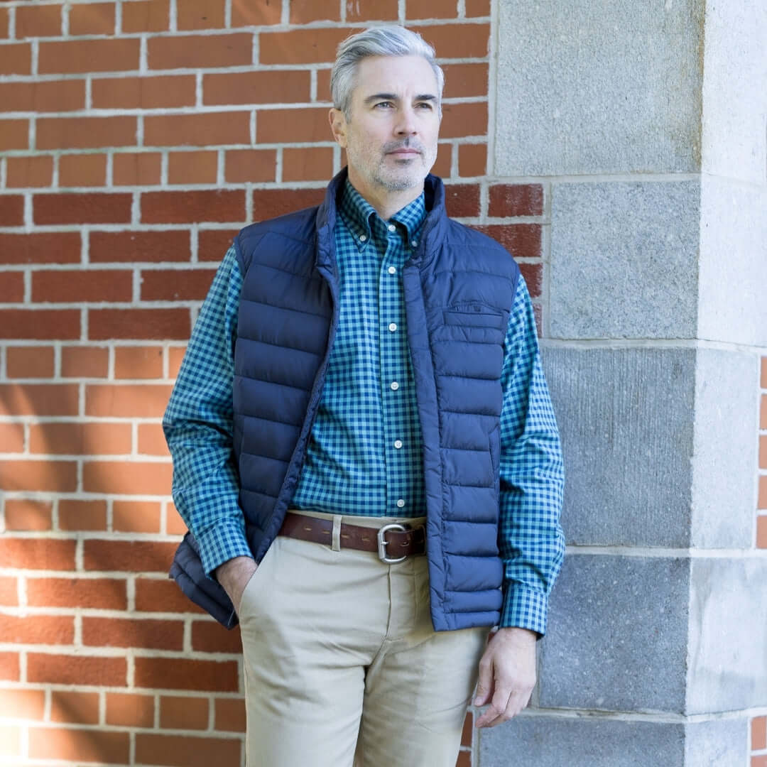 Weatherproof® X MagnaReady® Puffer Magnetic Front Navy Vest worn by a model against a brick wall.