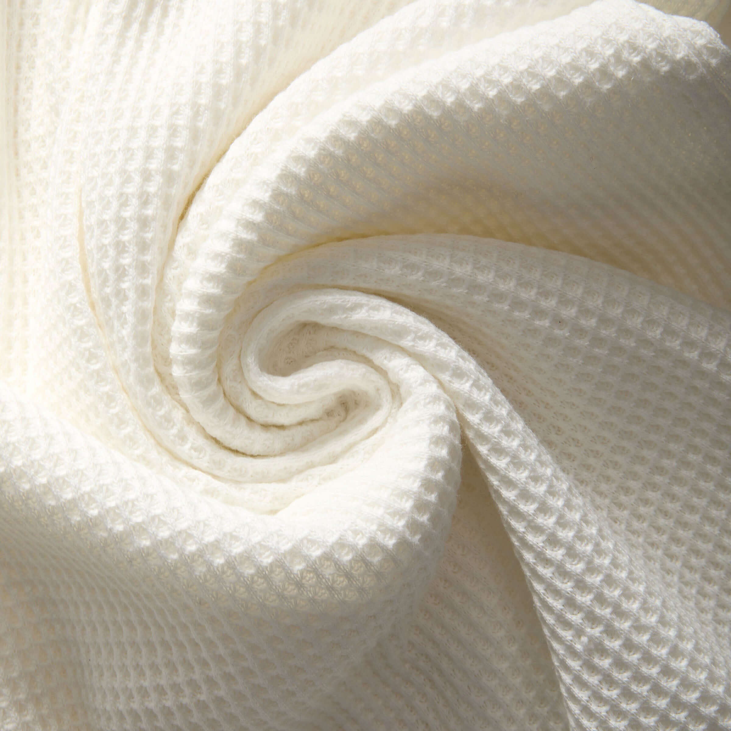 Close-up of soft and cozy waffle knit fabric in white, perfect for casual shirts with comfort and style.