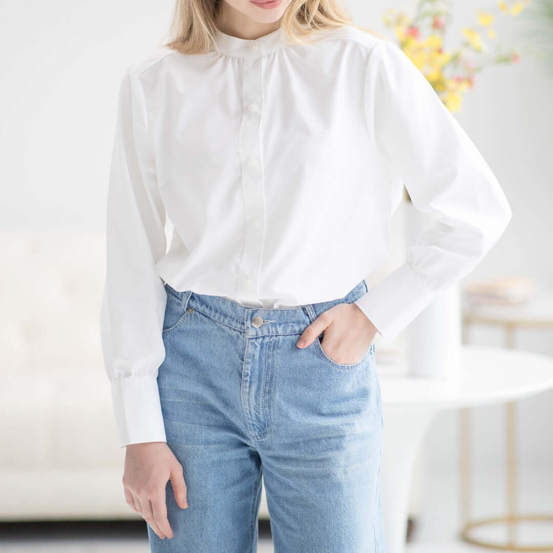 Women wearing a classic white adaptive magnetic blouse paired with blue jeans in a bright, stylish setting.