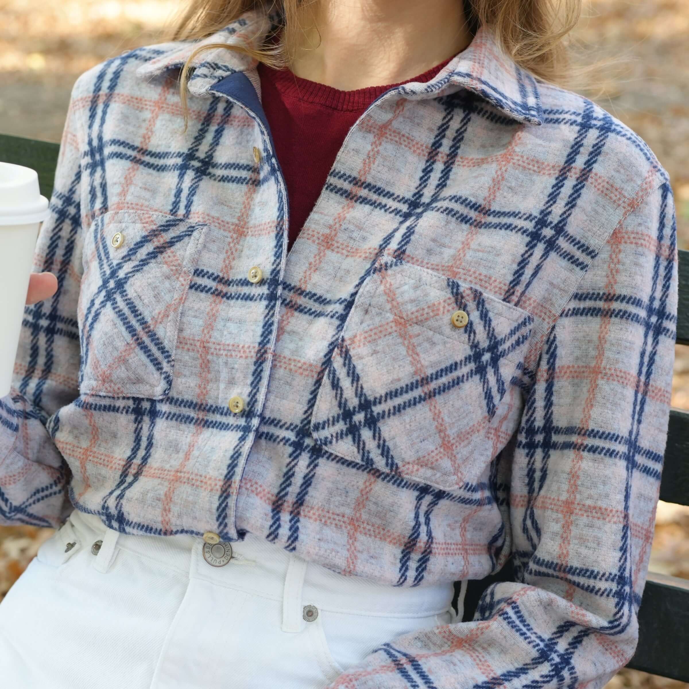 Women's flannel shirt in plaid design, featuring pink, navy, and gray tones for a stylish and comfortable look.