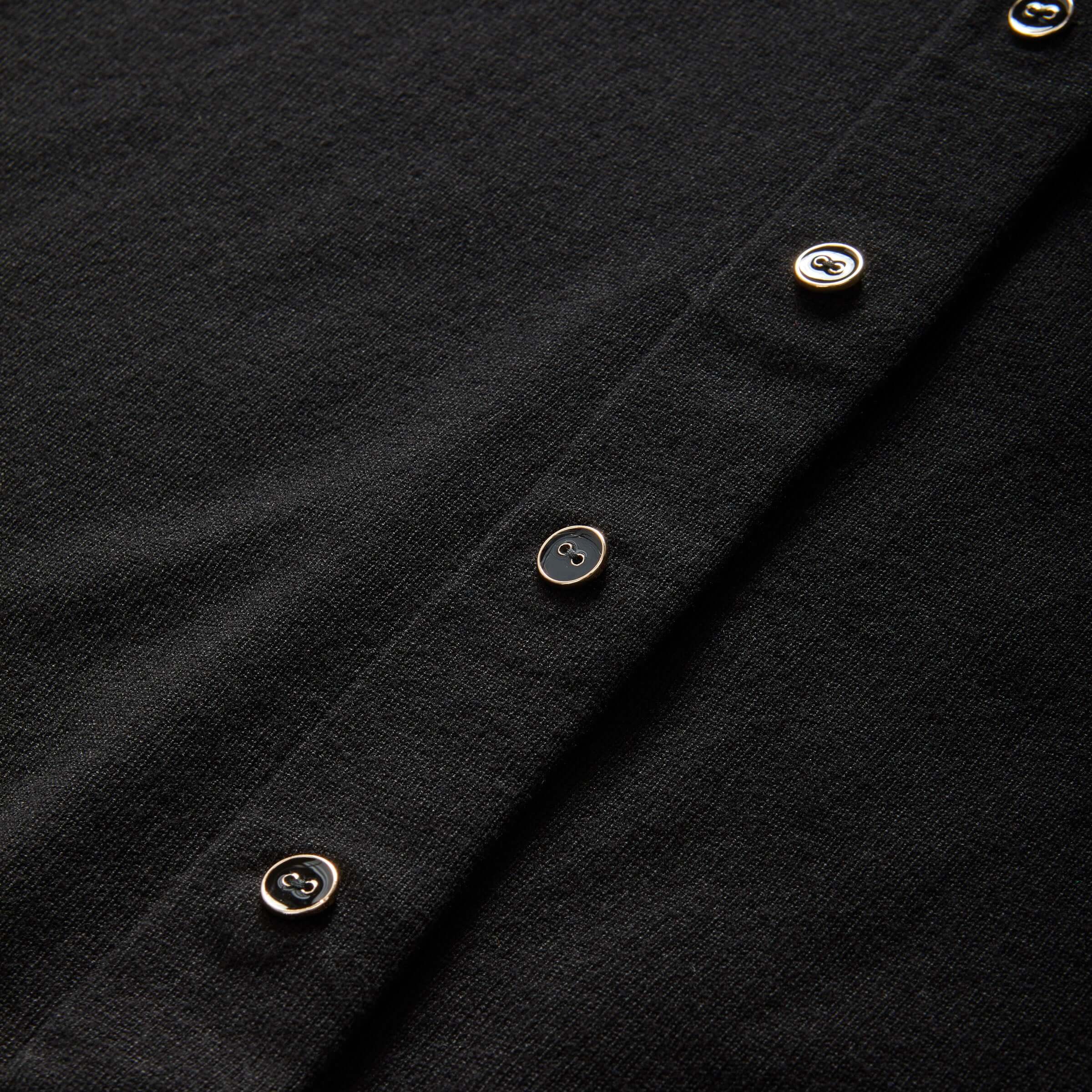 Close-up of black women's adaptive cardigan sweater with gold buttons, showcasing MagnaReady® magnetic technology.