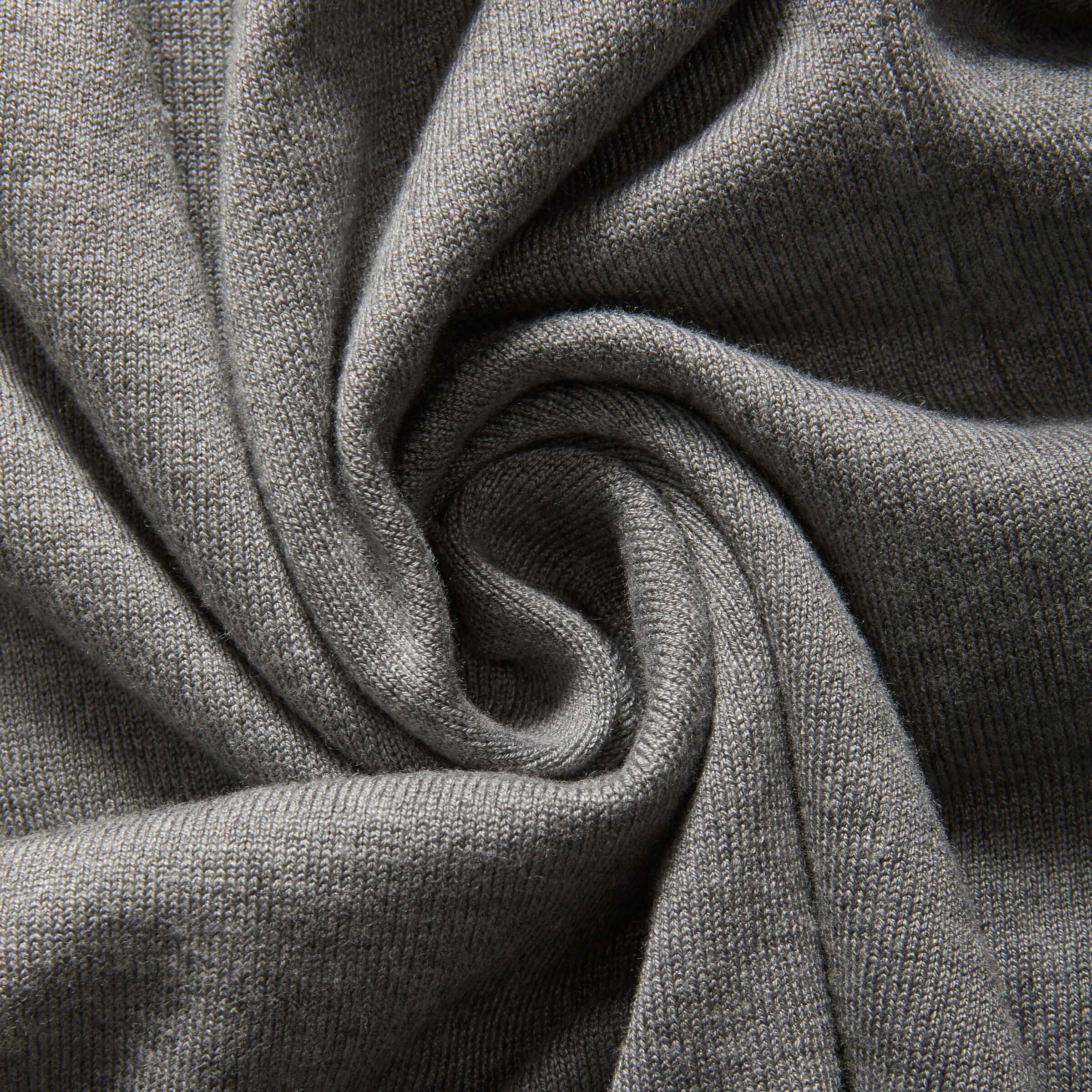 Grey knit fabric showcasing softness and texture, ideal for women's adaptive clothing like cardigans.