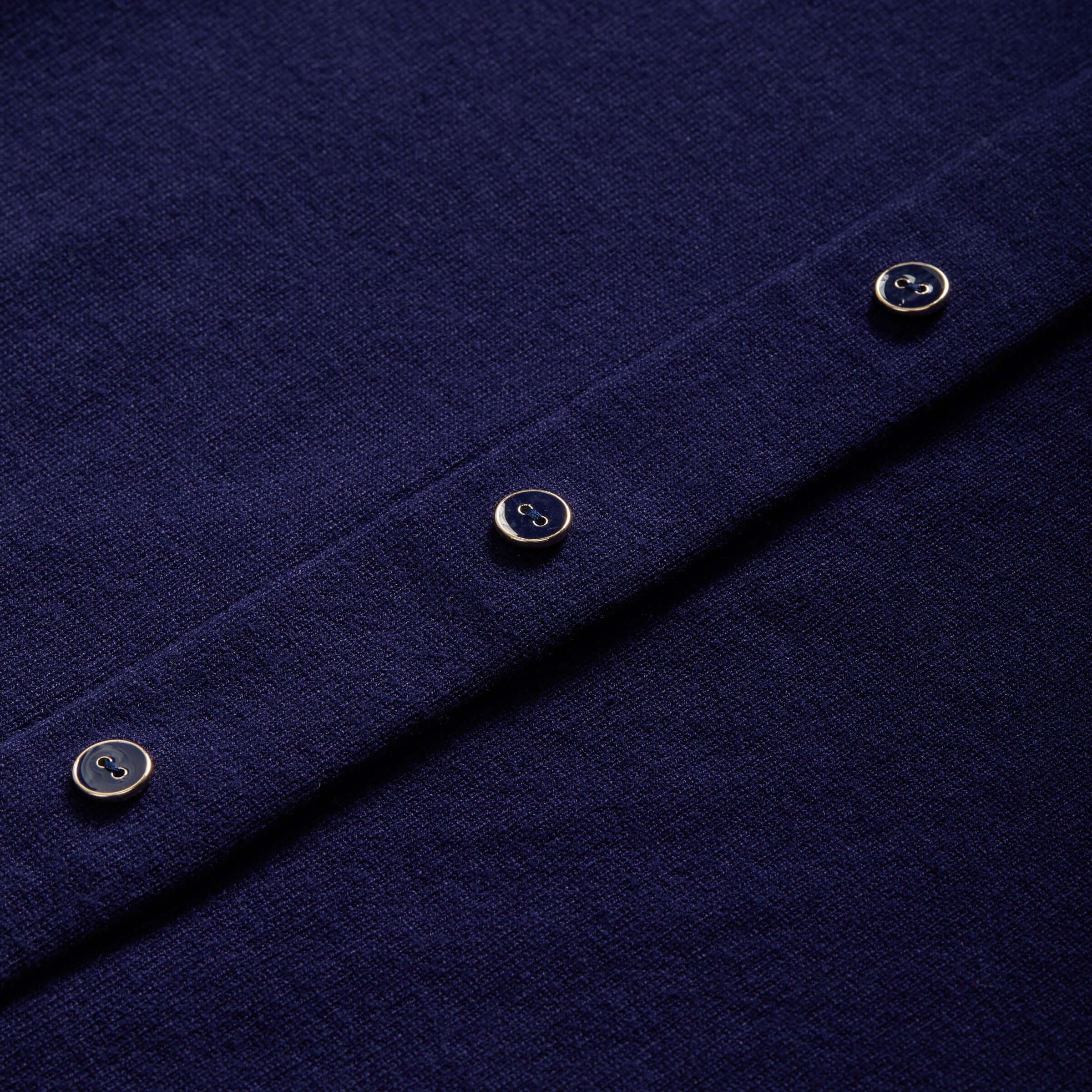 Close-up of navy women's adaptive cardigan with buttons showcasing the soft knit texture.