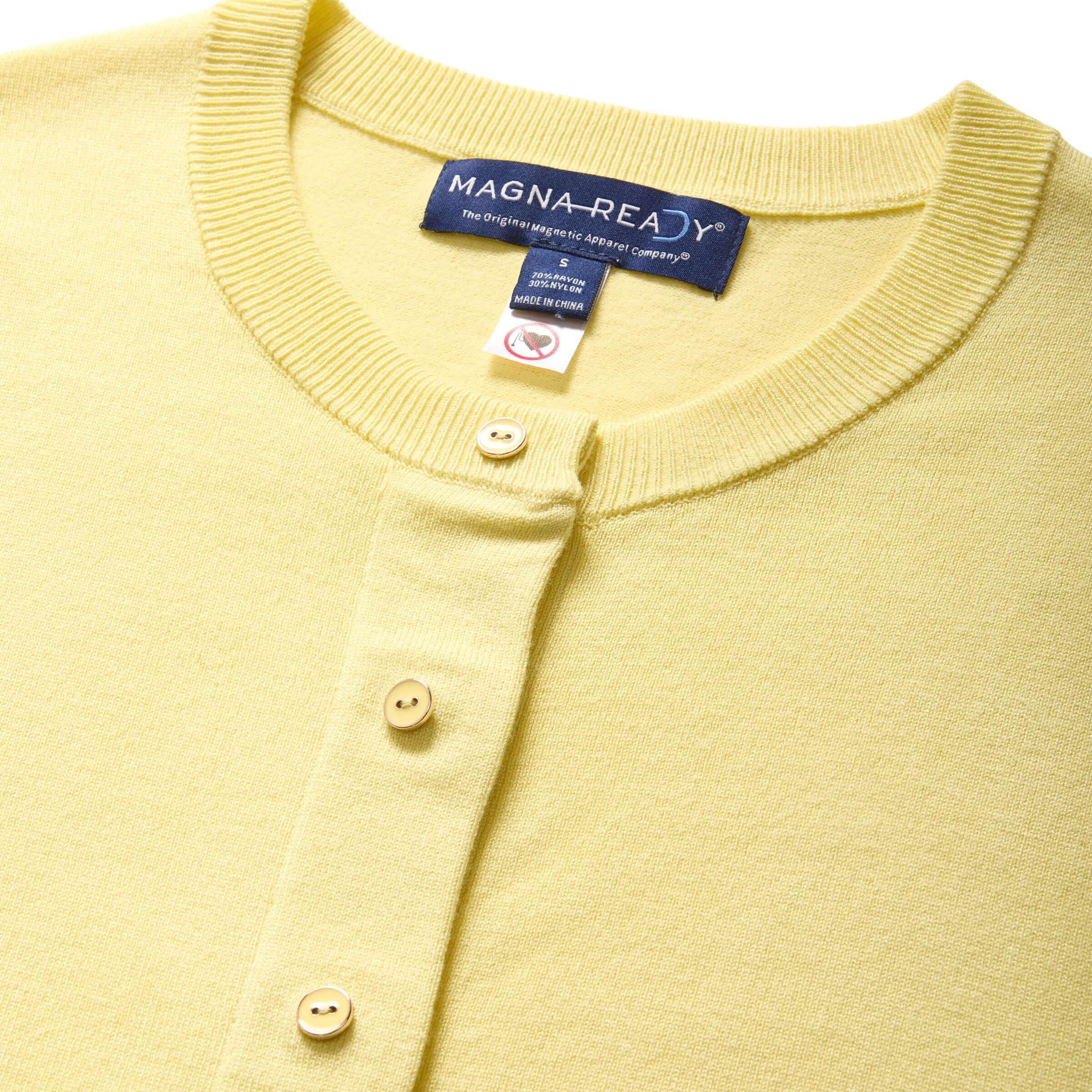 Close-up of yellow women's adaptive cardigan sweater with MagnaReady® technology for easy dressing.