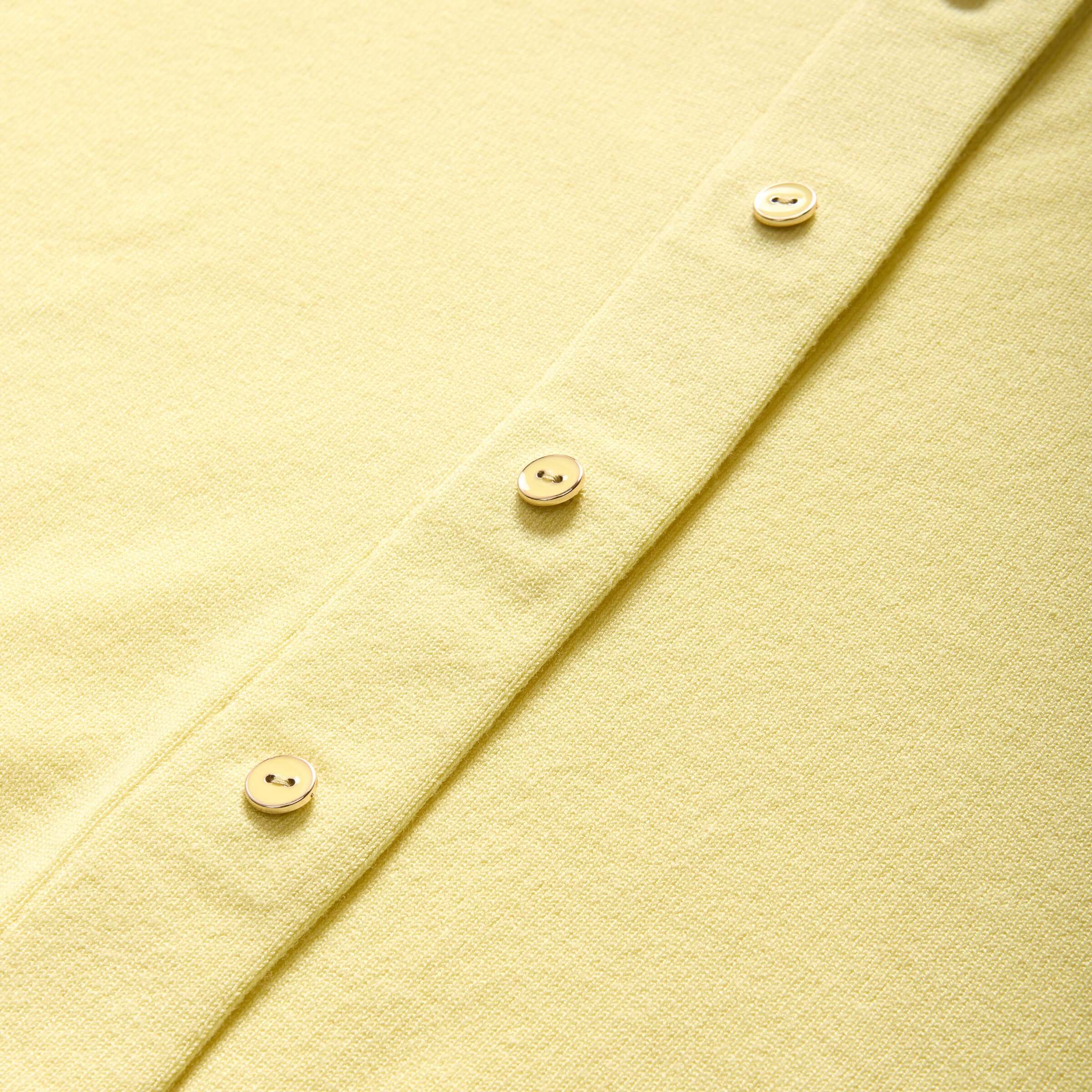 Close-up of the yellow Women's Adaptive Magnetic Front Knit Cardigan with buttons, showcasing its soft texture and design.
