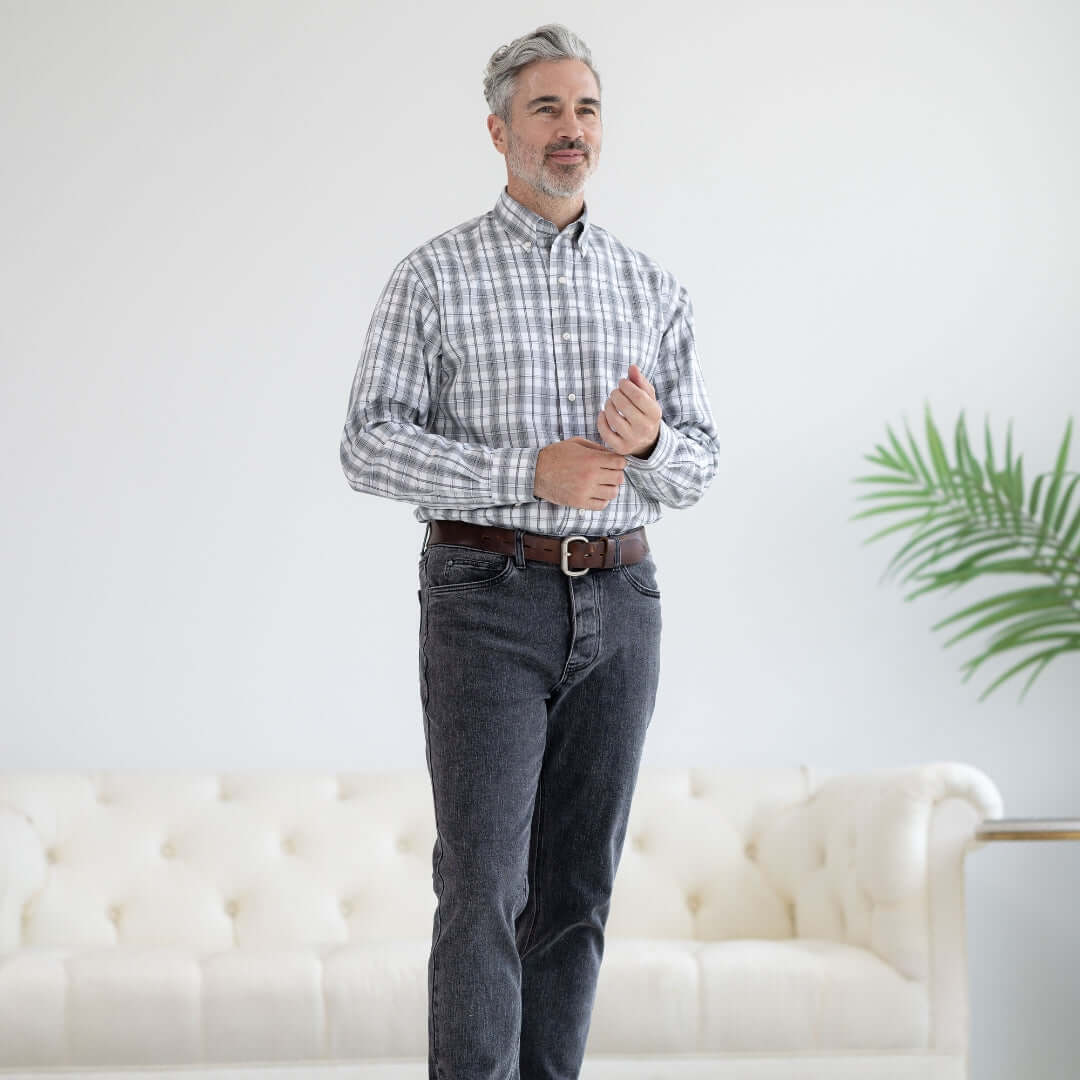 Man wearing a grey check long sleeve button down collar shirt with magnetic closures, designed for easy dressing.