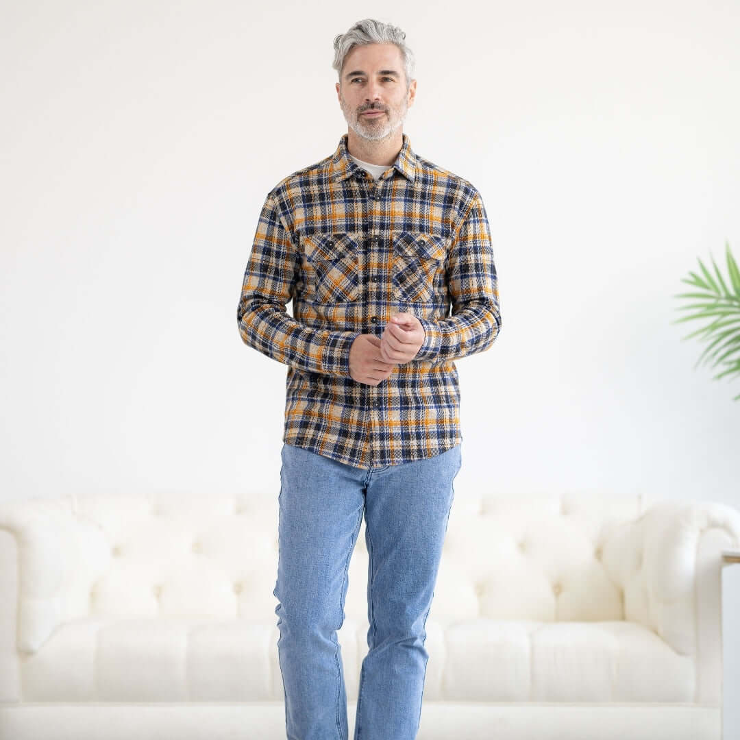 Adaptive Blue and Orange Flannel Shirt with Magnetic Closures worn by a man standing in a stylish living room.