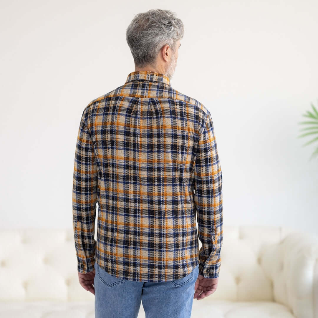 Back view of a man wearing an Adaptive Blue and Orange Flannel Shirt with Magnetic Closures.