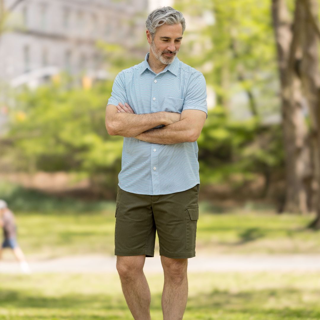 Adaptive Cargo Twill Short with Magnetic Closures - Olive on a man standing outdoors, featuring a relaxed fit.