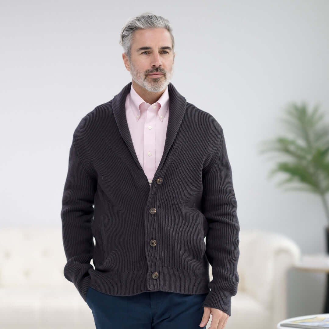 Man wearing a charcoal adaptive ribbed cotton shawl collar cardigan with magnetic button front and pockets.