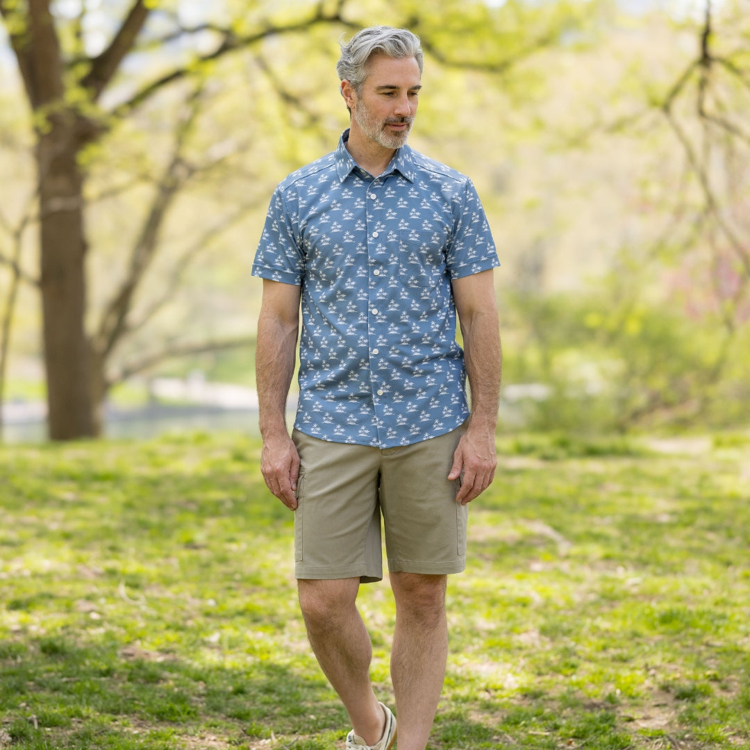 Adaptive Cooling Magnetic Front Short Sleeve Shirt in Blue Palm worn by a man outdoors.