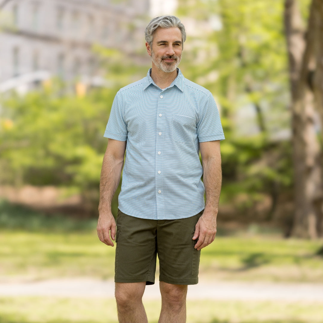 Adaptive Cooling Magnetic Front Short Sleeve Shirt in Green Stripe worn by man outdoors.