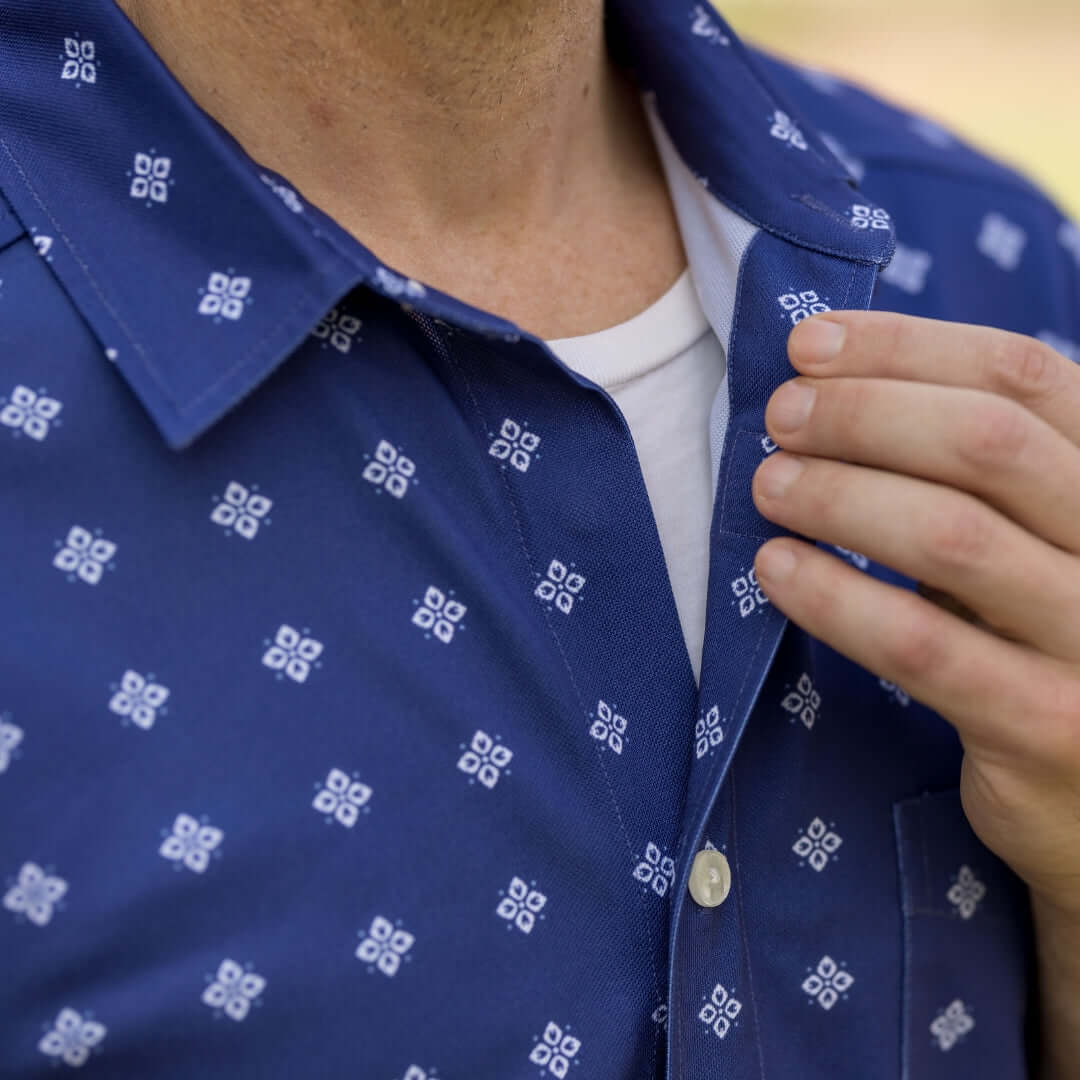 Adaptive Cooling Magnetic Front Short Sleeve Shirt in Navy Diamond displayed on a model adjusting the collar.