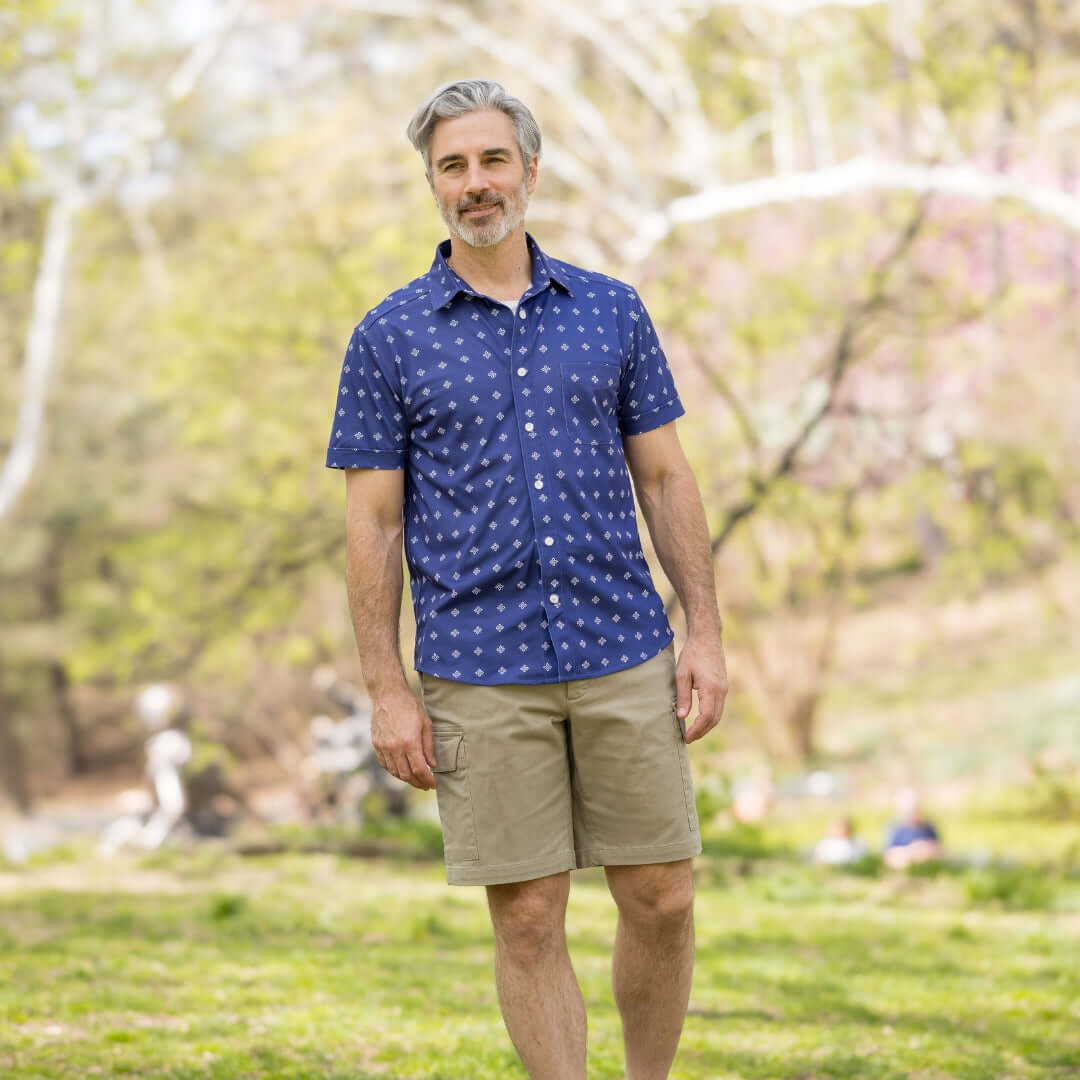 Adaptive Cooling Magnetic Front Short Sleeve Shirt in Navy Diamond worn outdoors by man in a natural setting.