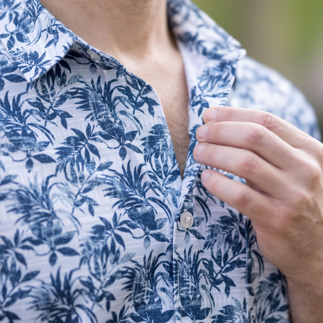 Adaptive Cooling Magnetic Front Short Sleeve Shirt in Blue Grey Palm, showcasing palm leaf pattern and button detail.