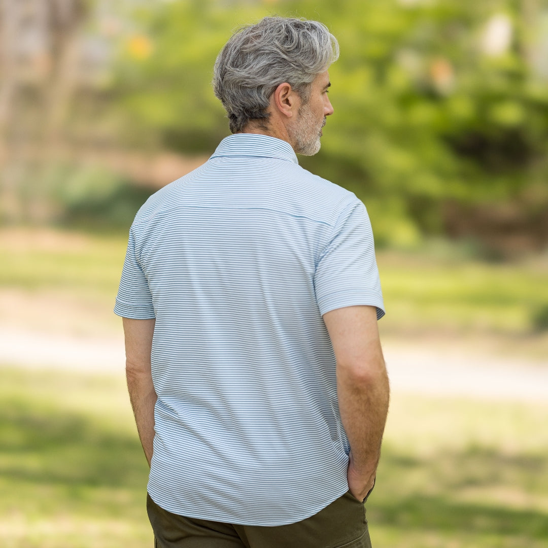 Adaptive Cooling Magnetic Front Short Sleeve Shirt in Green Stripe worn from the back in a natural setting.