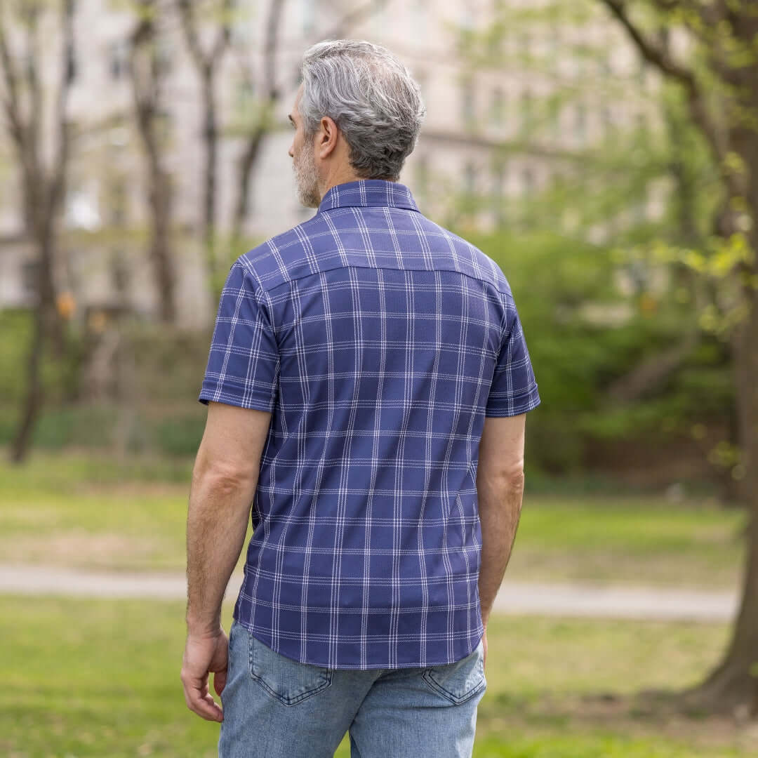 Adaptive Cooling Magnetic Front Short Sleeve Shirt in Navy Windowpane worn by a man outdoors.