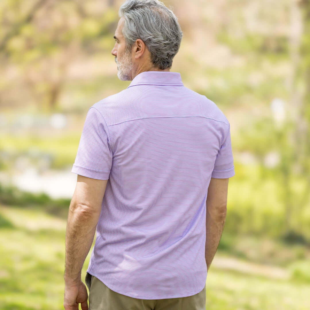 Adaptive Cooling Magnetic Front Short Sleeve Shirt in Pink and Blue Stripe, back view on a man outdoors.