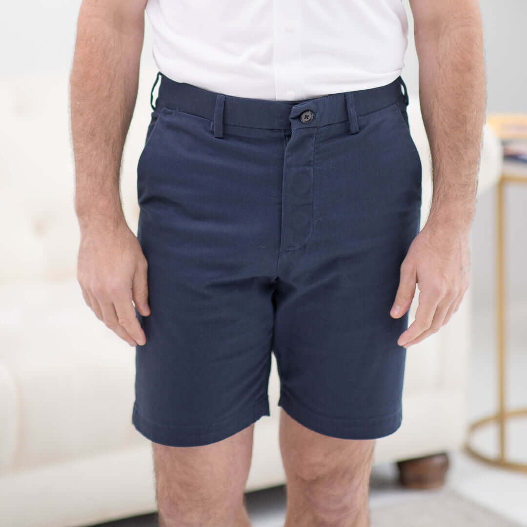 Man wearing navy adaptive chino twill shorts with magnetic closures, designed for effortless dressing.