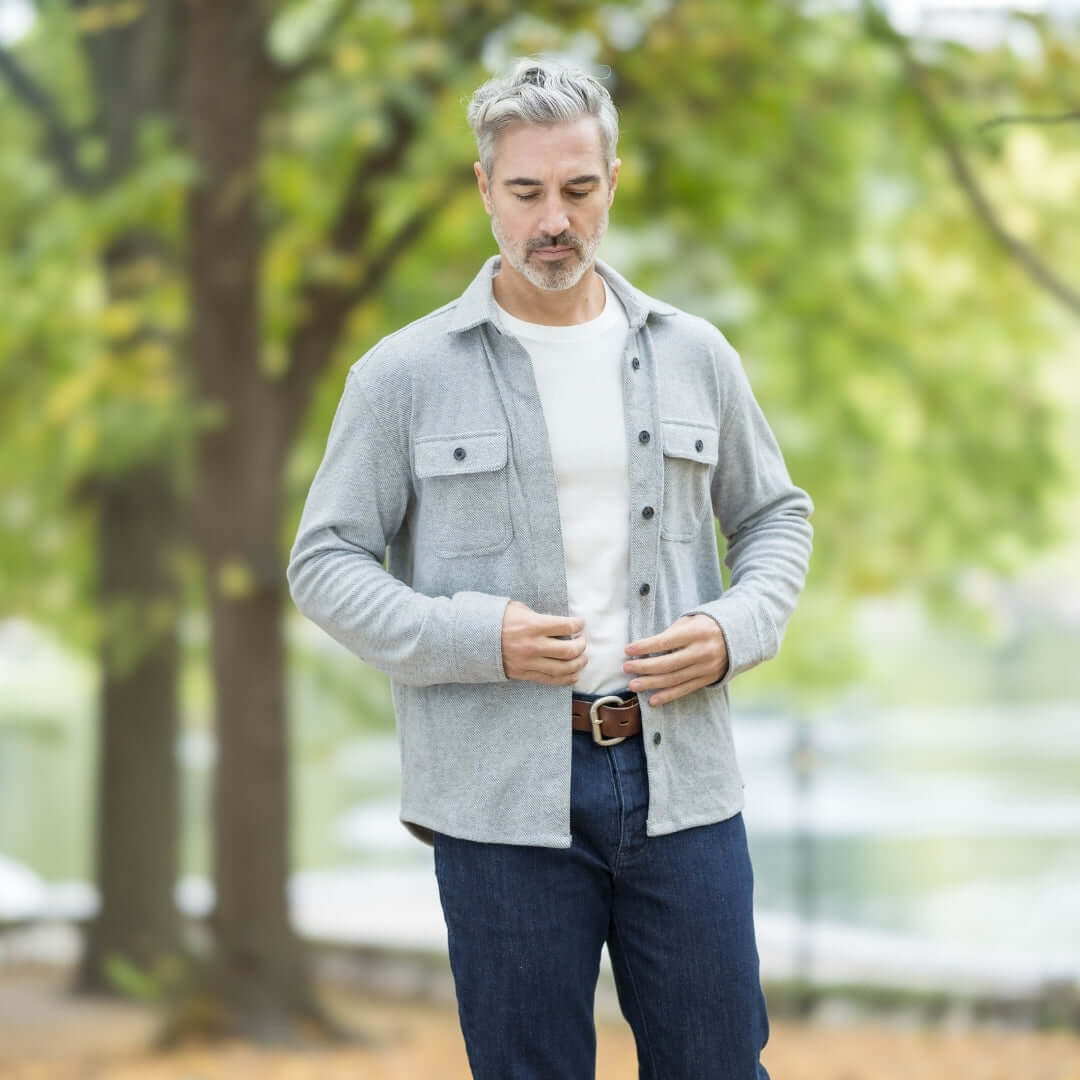 Man wearing a grey flannel shirt outdoors, showcasing style and versatility for fall layering.