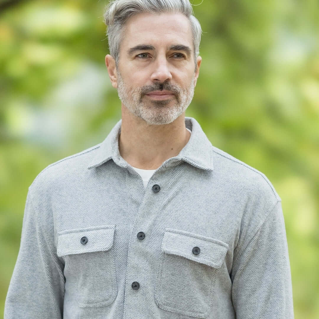 Man wearing adaptive grey flannel shirt with magnetic closures, perfect for layering in changing seasons.