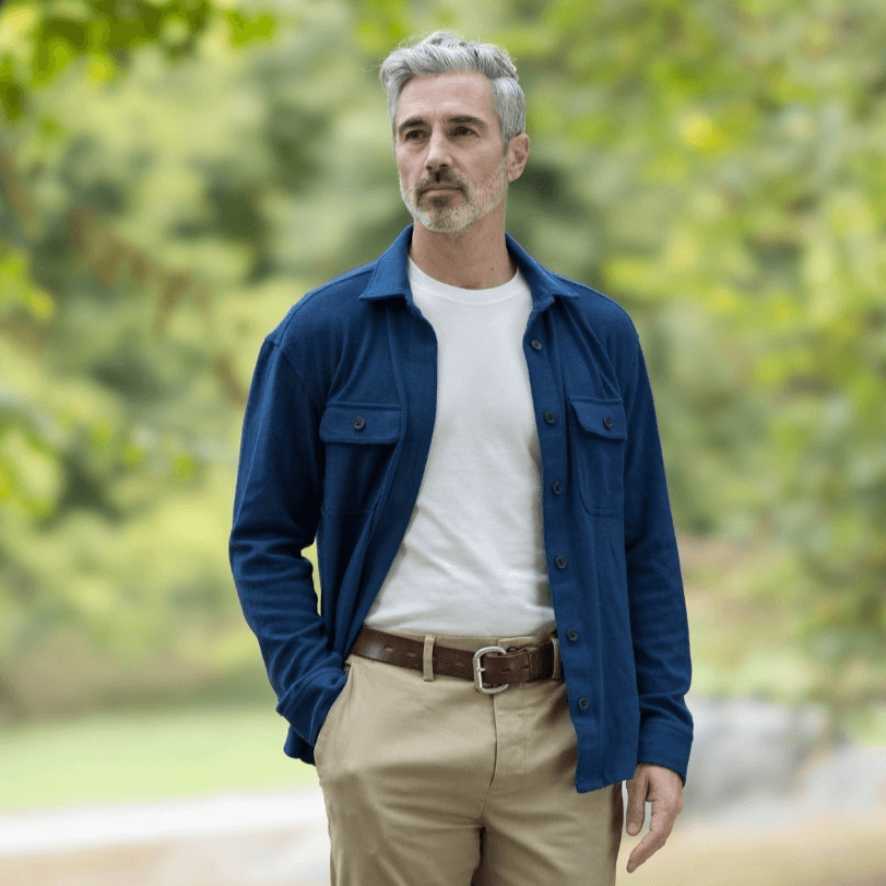 Man wearing a stylish adaptive indigo flannel shirt jacket outdoors, showcasing versatility and fashion-forward design.