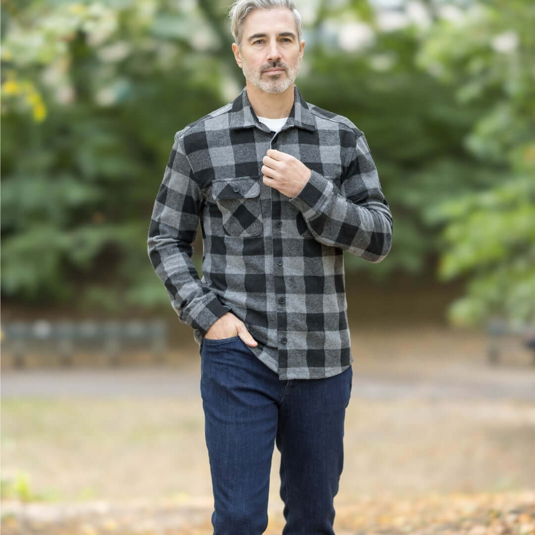 Stylish man wearing an adaptive black buffalo check flannel shirt combo in an outdoor setting.