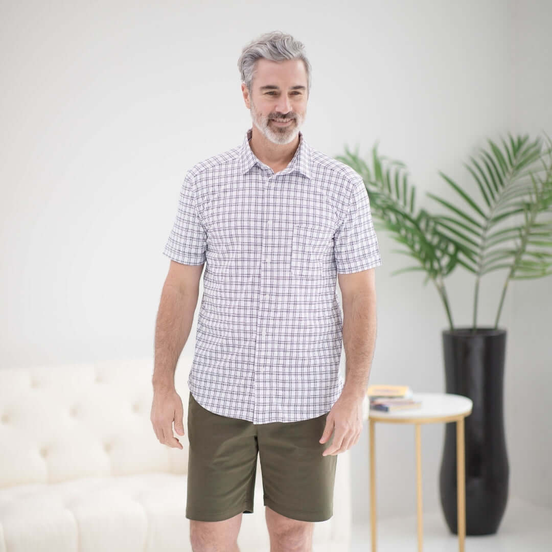 Man wearing an adaptive magnetic cooling shirt in black and white grid, ideal for limited mobility and comfort.