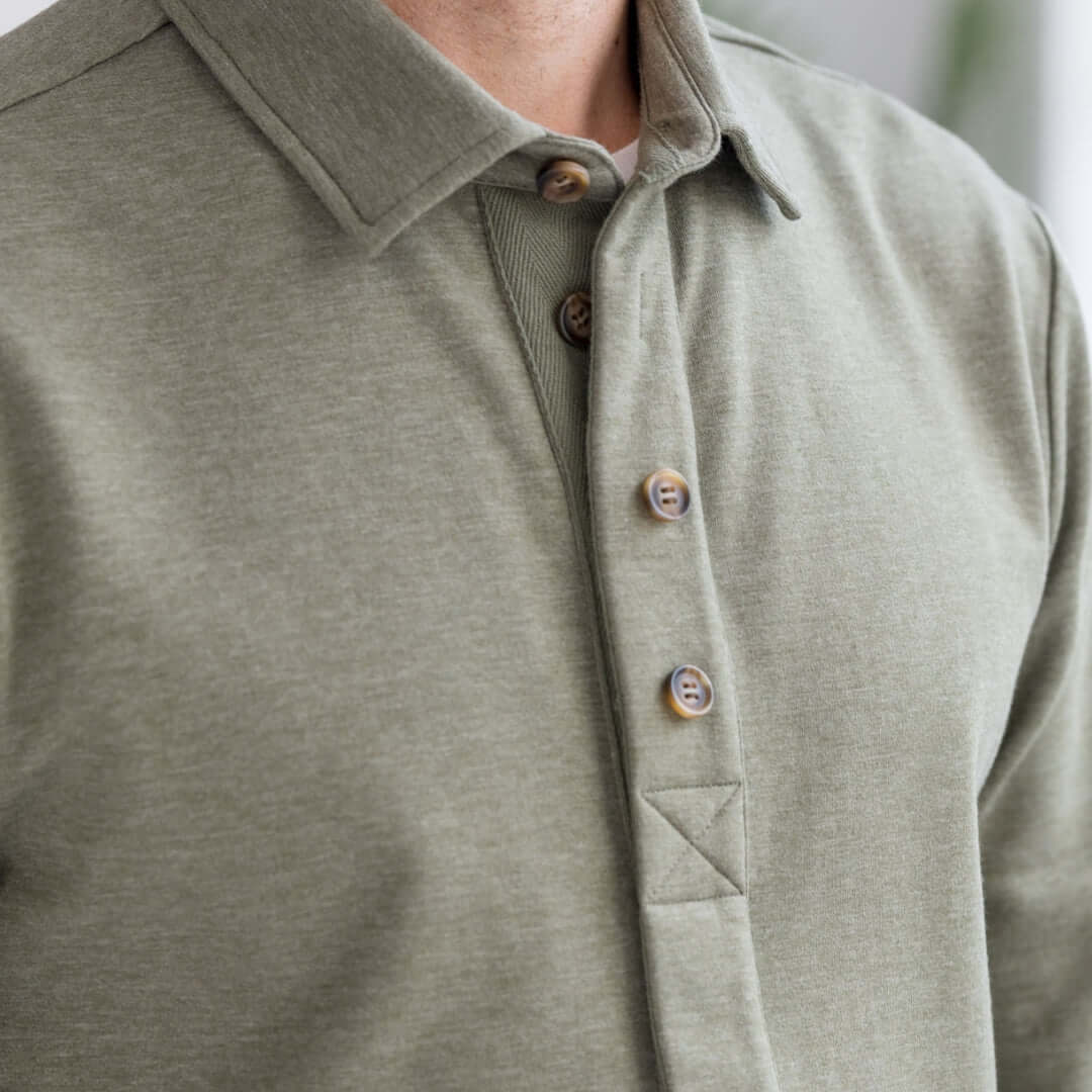 Close-up of the Adaptive Magnetic Front Sweatshirt in Heathered Olive featuring buttons and a collared design for ease of wear.