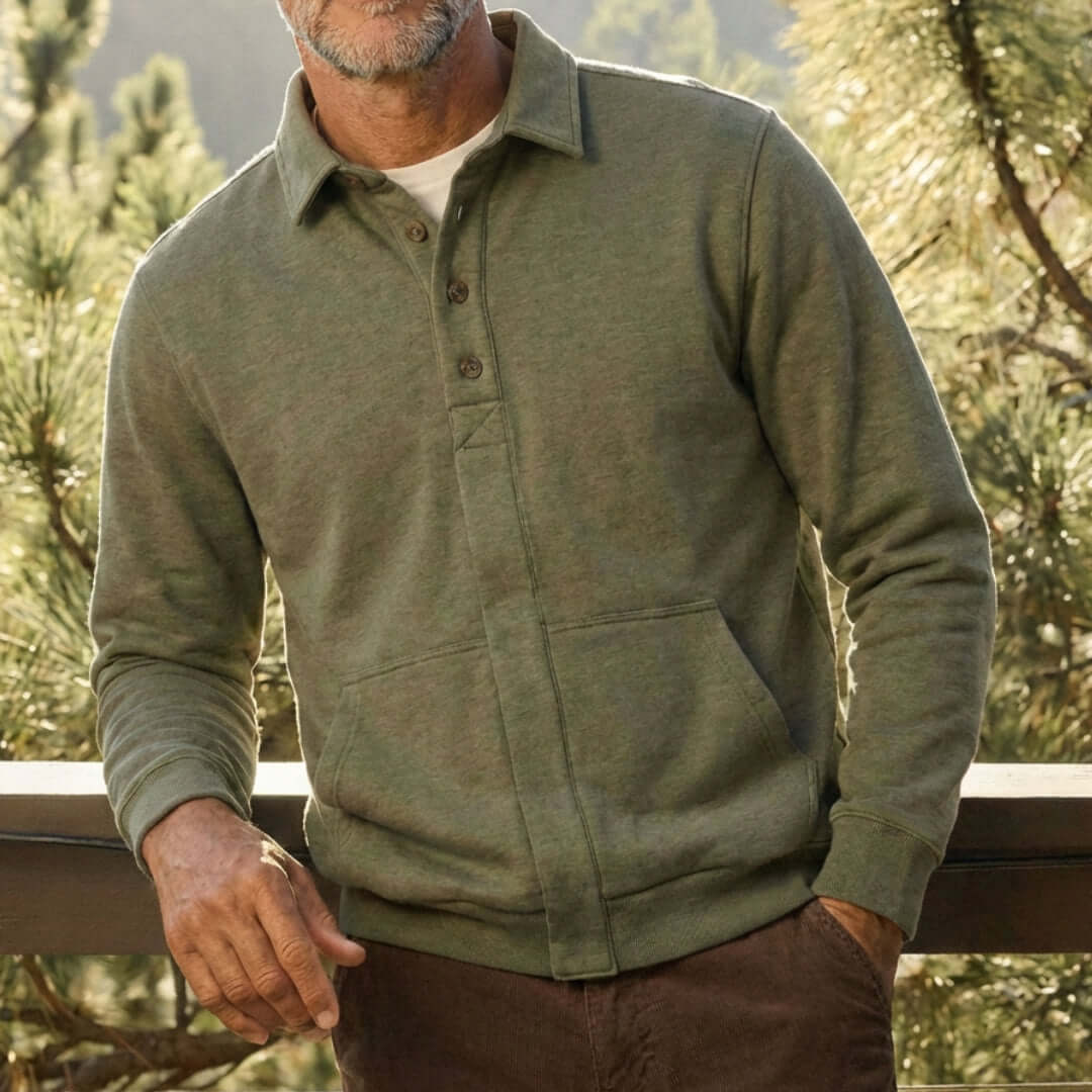 The Adaptive Magnetic Front Sweatshirt in Heathered Olive worn by a man in a natural setting.