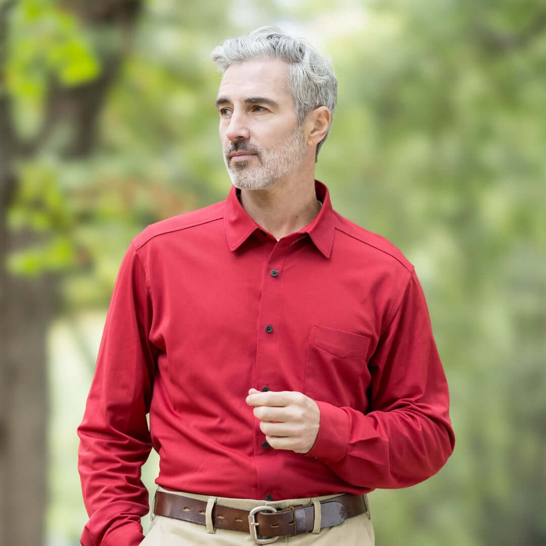 Model wearing a red long sleeve cooling tech polo shirt outdoors, showcasing its stylish design and magnetic buttons.