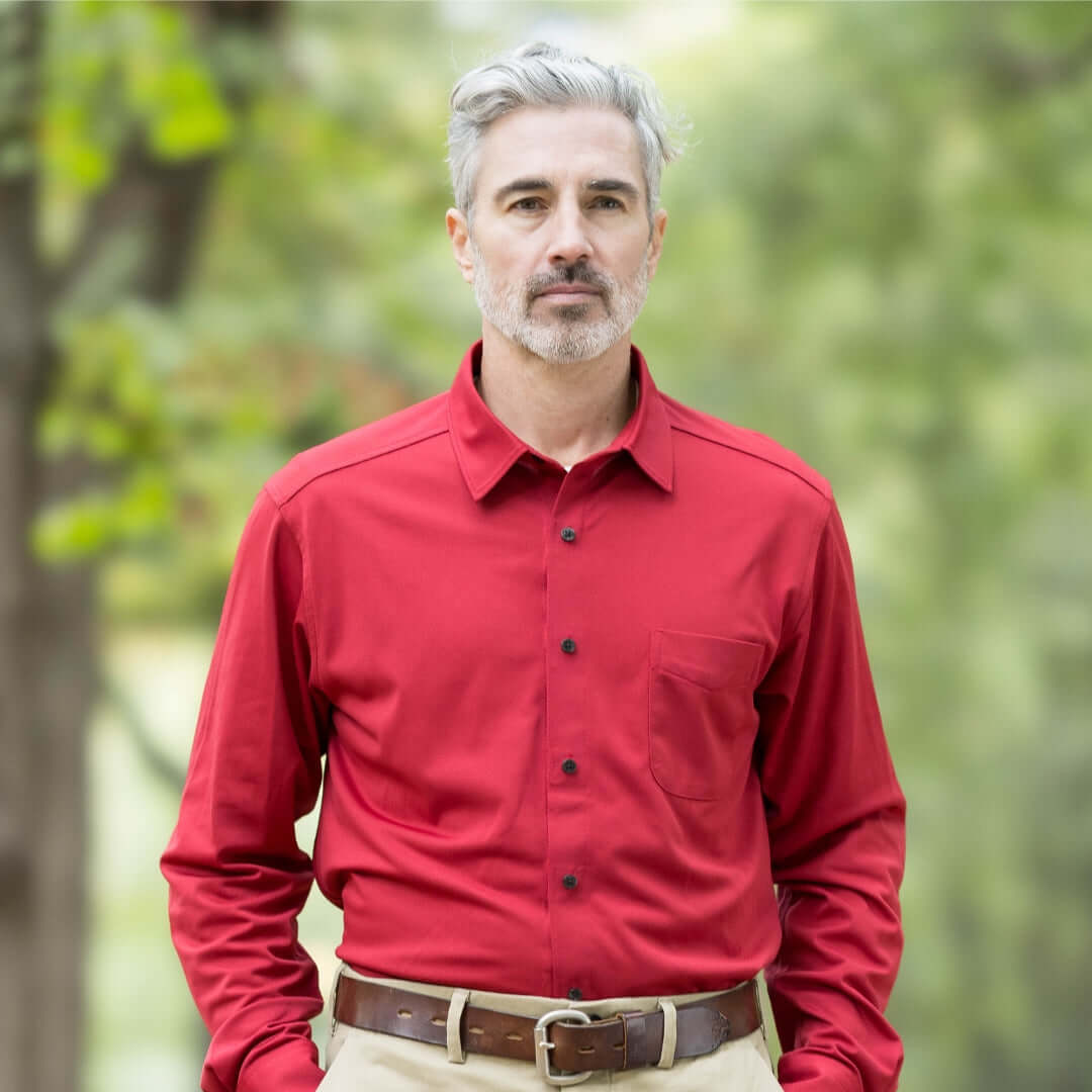 Man wearing adaptive Rio Red long sleeve polo with pocket, perfect for comfort and all-day functionality.