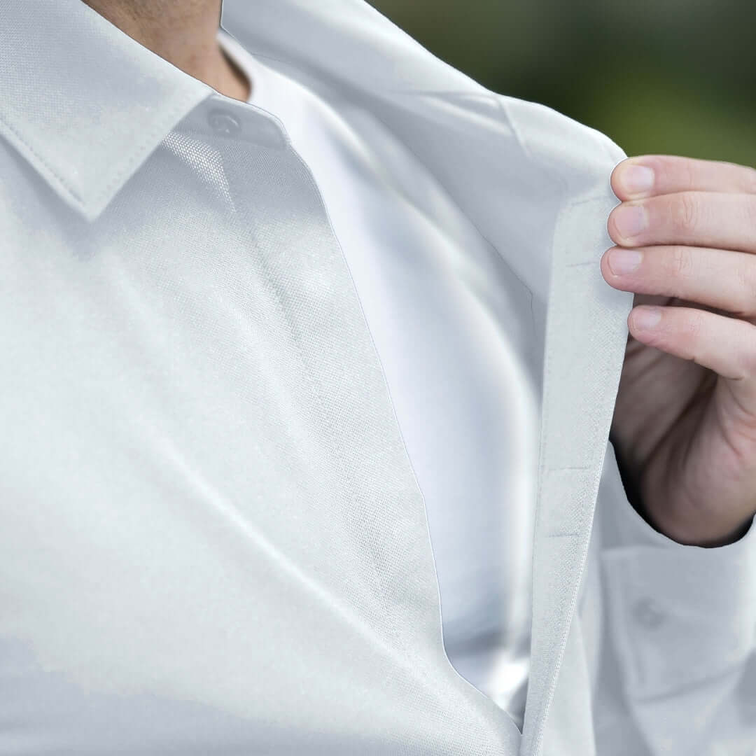 Adaptive White Magnetic Front Long Sleeve Cooling Adaptive Polo with Pocket being worn, featuring a sleek design and easy access.