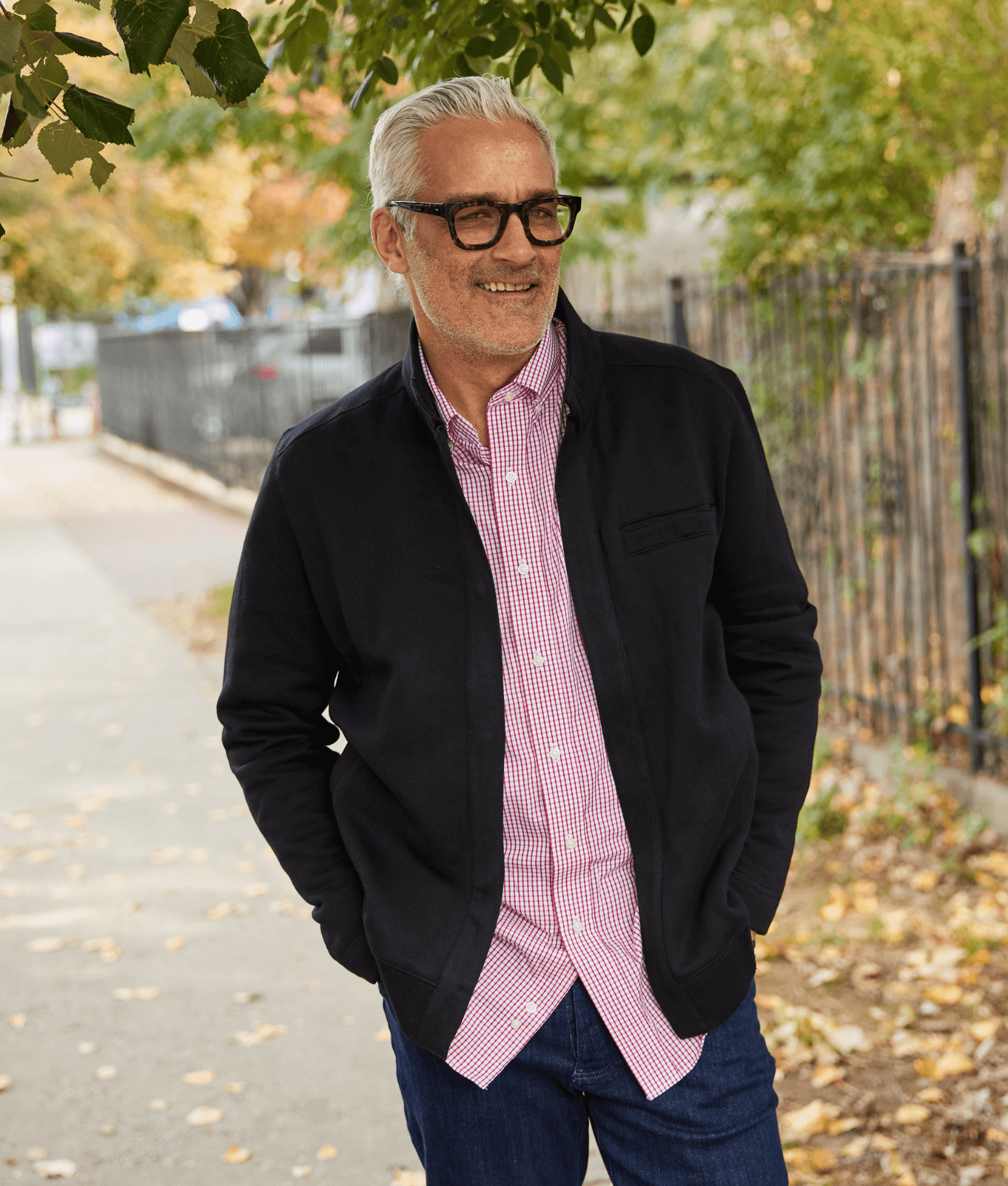 Man wearing a black knit fleece Dillon jacket, enjoying a walk outdoors in fall. Perfect for comfort and style.
