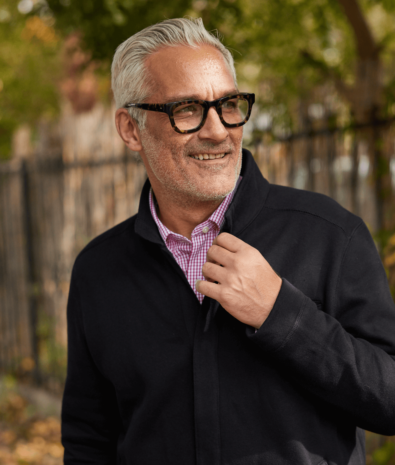 Man wearing a stylish black knit fleece Dillon jacket, enjoying a sunny day outdoors.