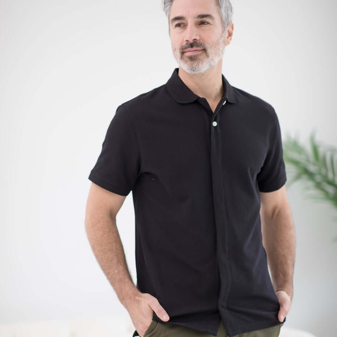 Black pique knit short sleeve polo with magnetic closures, ideal for easy dressing and comfort.