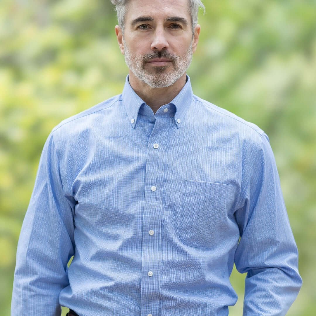 Blue long sleeve button-down shirt with magnetic closures, designed for adaptive dressing and ease of wear.