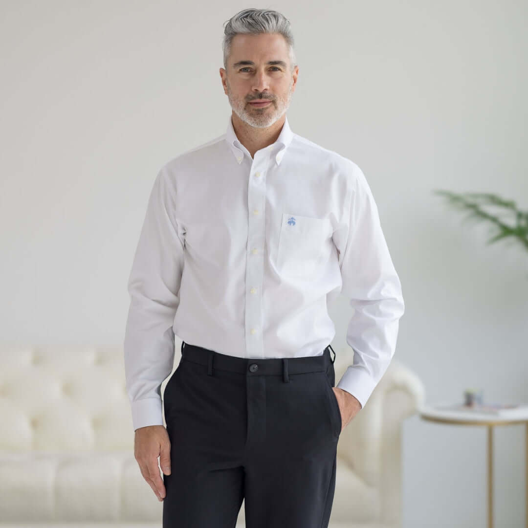 Man modeling a Brooks Brothers x MagnaReady white polo shirt with button-down collar and magnetic closures.