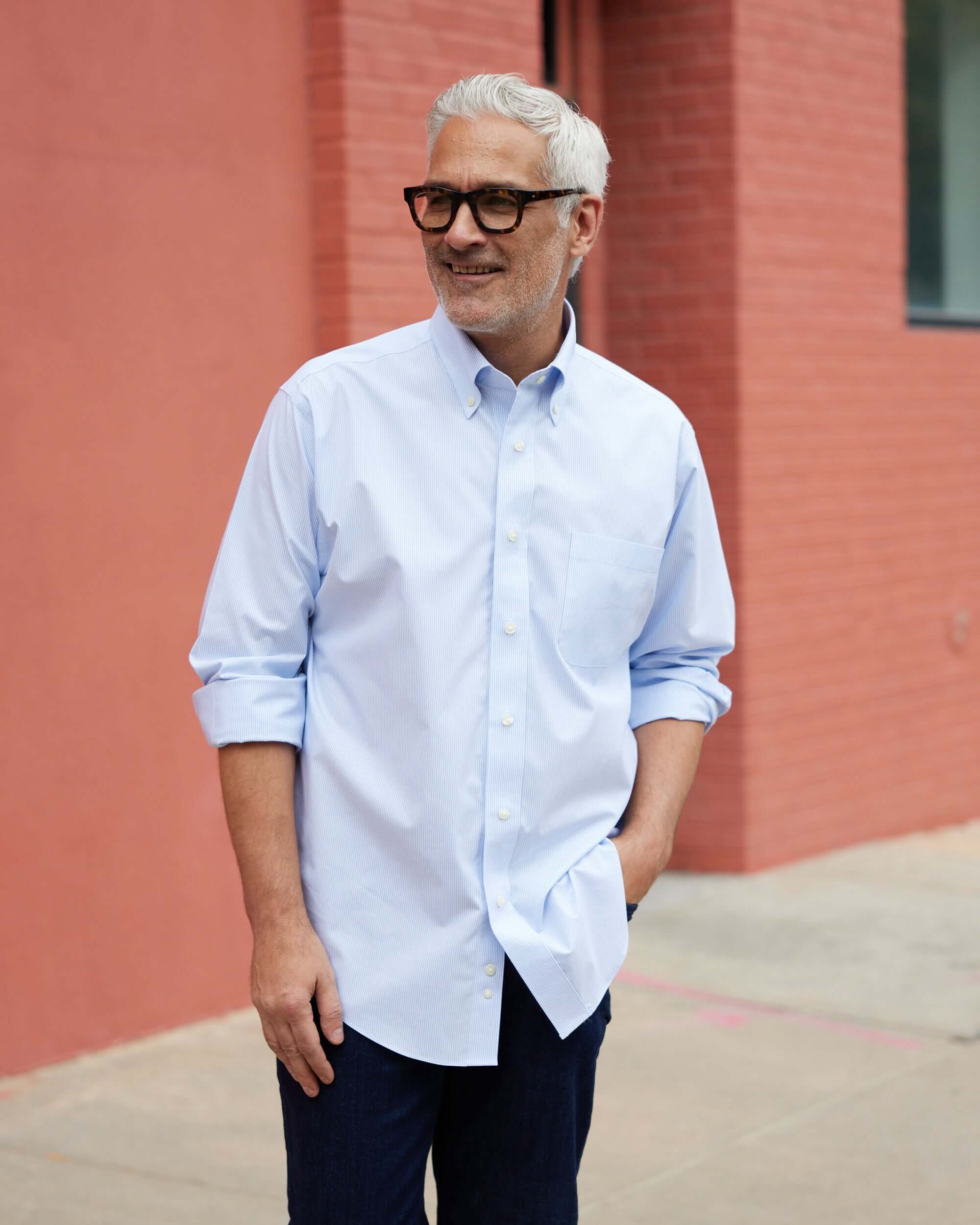 Man wearing Brooks Brothers x MagnaReady blue and white stripe button-down collar polo, showcasing adaptive technology.