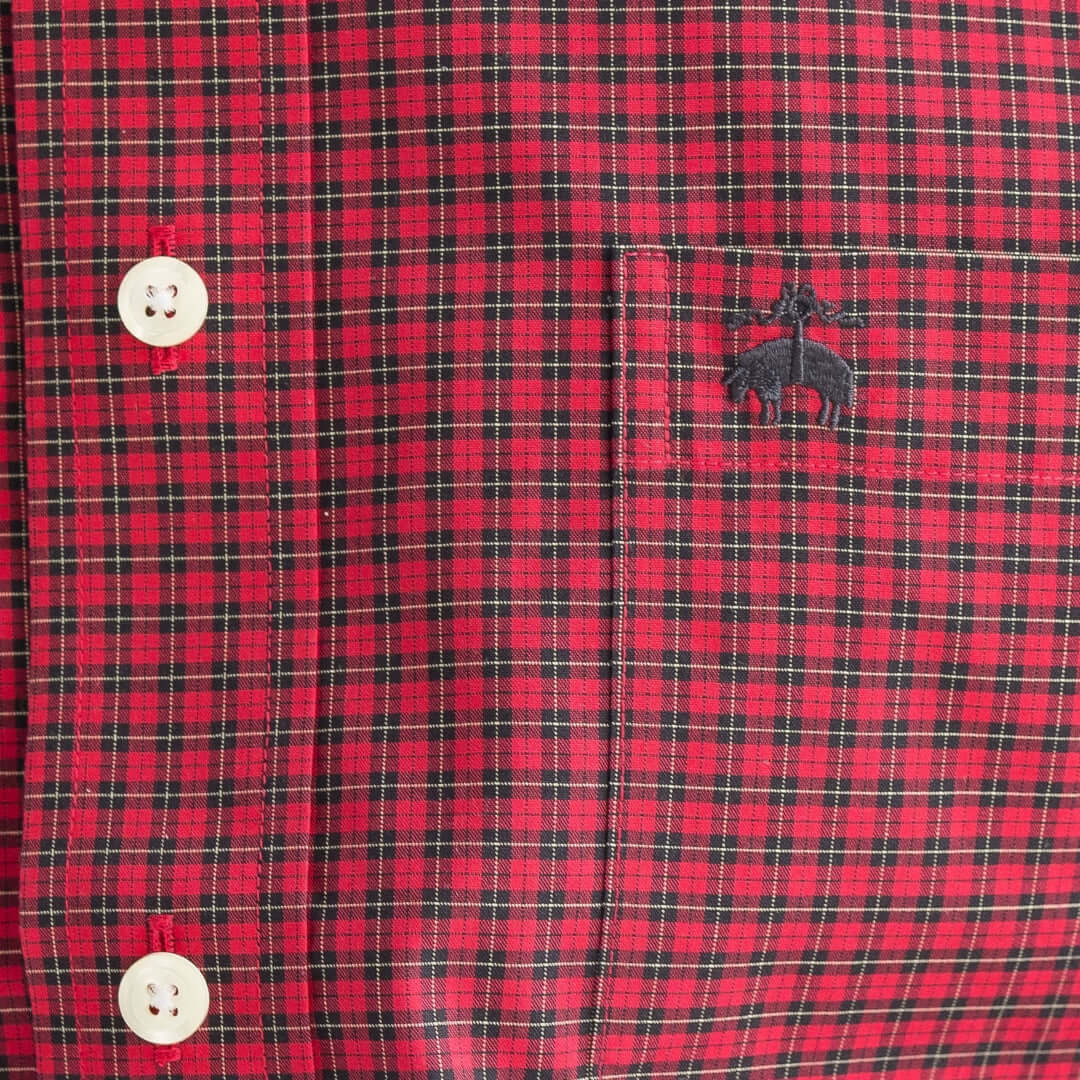 Close-up of Brooks Brothers plaid button-down shirt with magnetic closures, featuring the logo embroidery and classic tartan design.