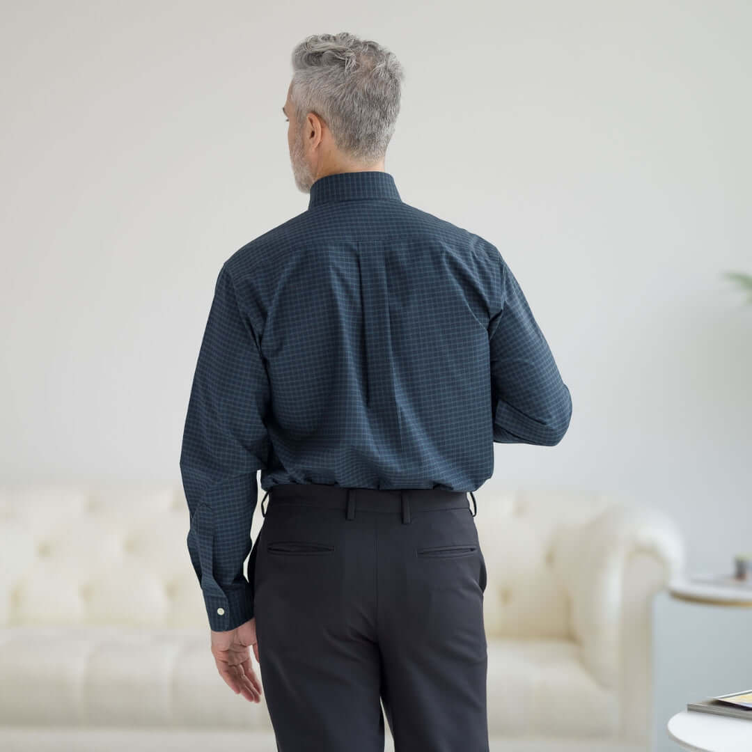 Back view of a man wearing Brooks Brothers MagnaReady black watch button-down shirt, showcasing its adaptive technology.