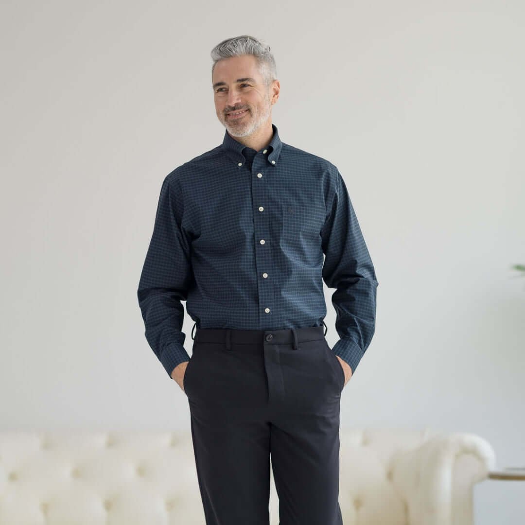 Man wearing Brooks Brothers x MagnaReady black watch button-down shirt with magnetic closures, celebrating 125 years of innovation.