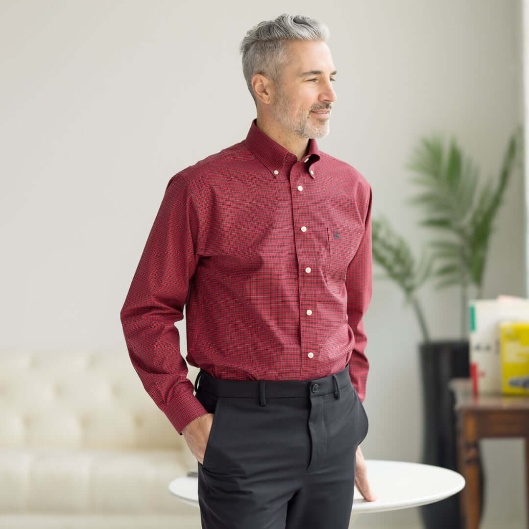 Man wearing Brooks Brothers x MagnaReady red tartan plaid shirt with magnetic closures, showcasing adaptive technology.