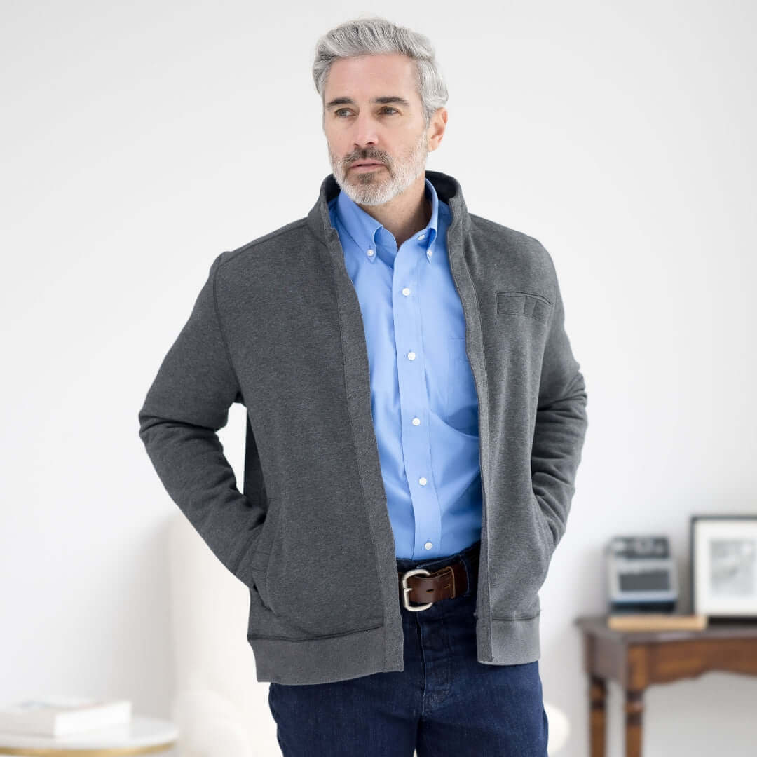 Man wearing a charcoal knit fleece Dillon jacket with magnetic closures, showcasing adaptive style and comfort.