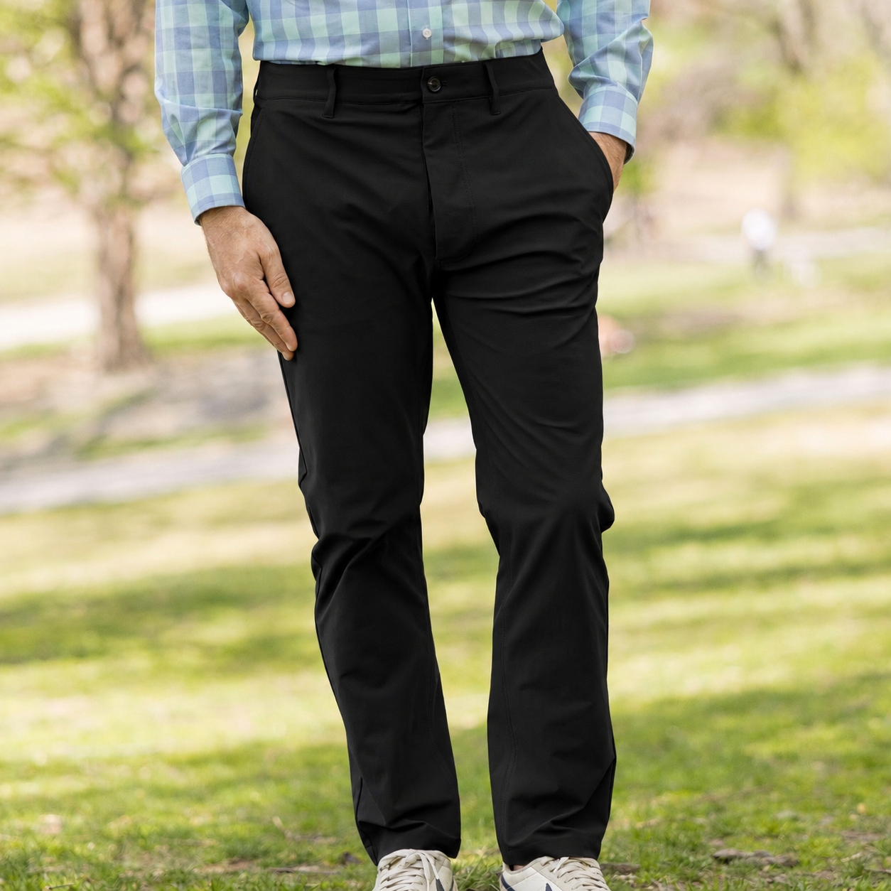 Flat Front Adaptive Stretch Tech Pant with Magnetic Closures - Black worn outdoors in a relaxed setting.