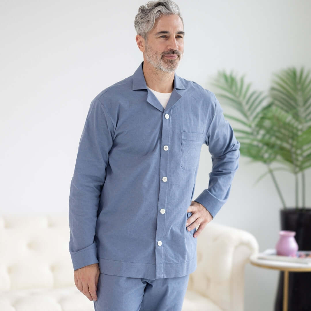 Long Sleeve Blue Brushed Flannel Pajama Top with Magnetic Closures modeled by a man in a living room.