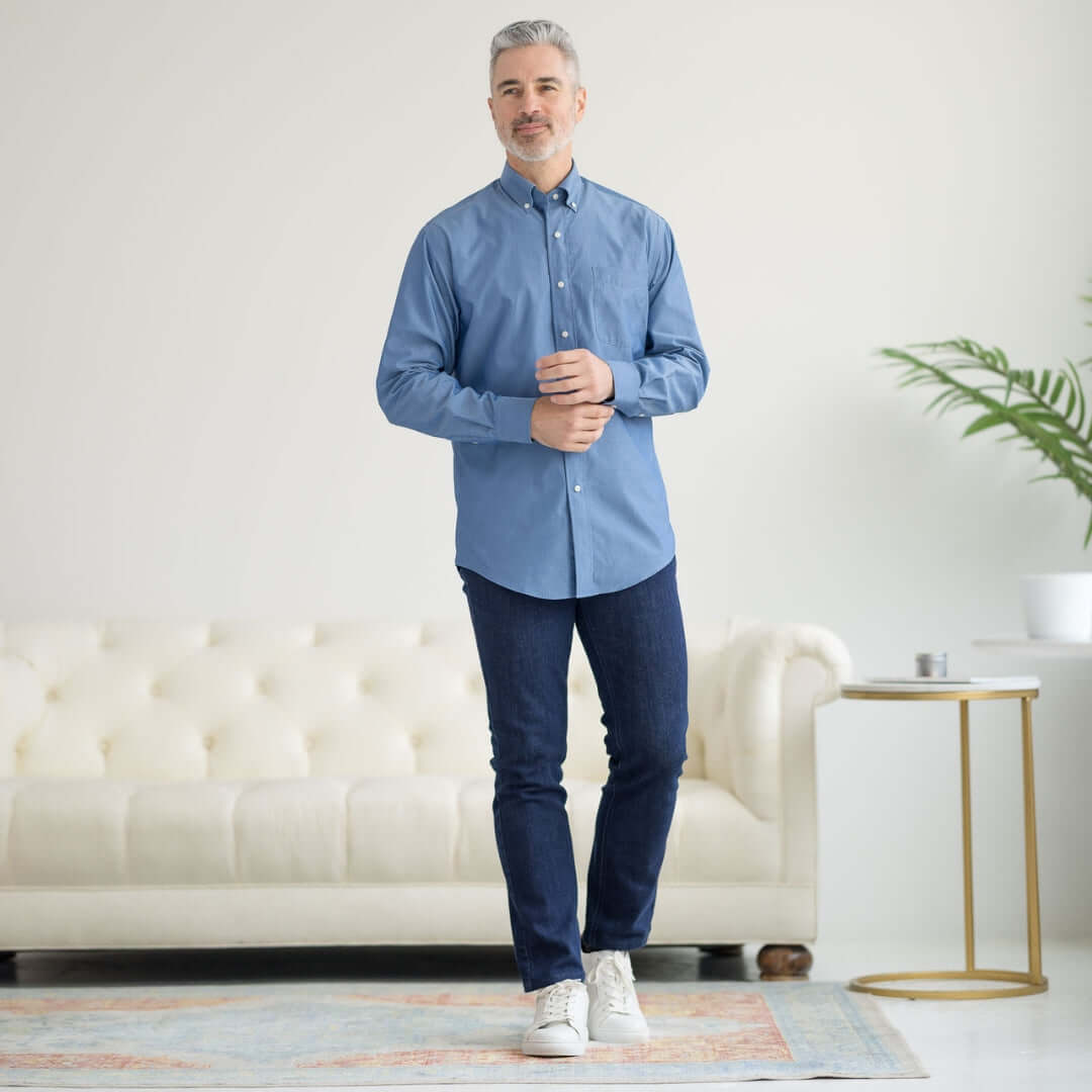 Man wearing a long sleeve blue chambray shirt with magnetic closures, showcasing adaptive fashion for easy dressing.