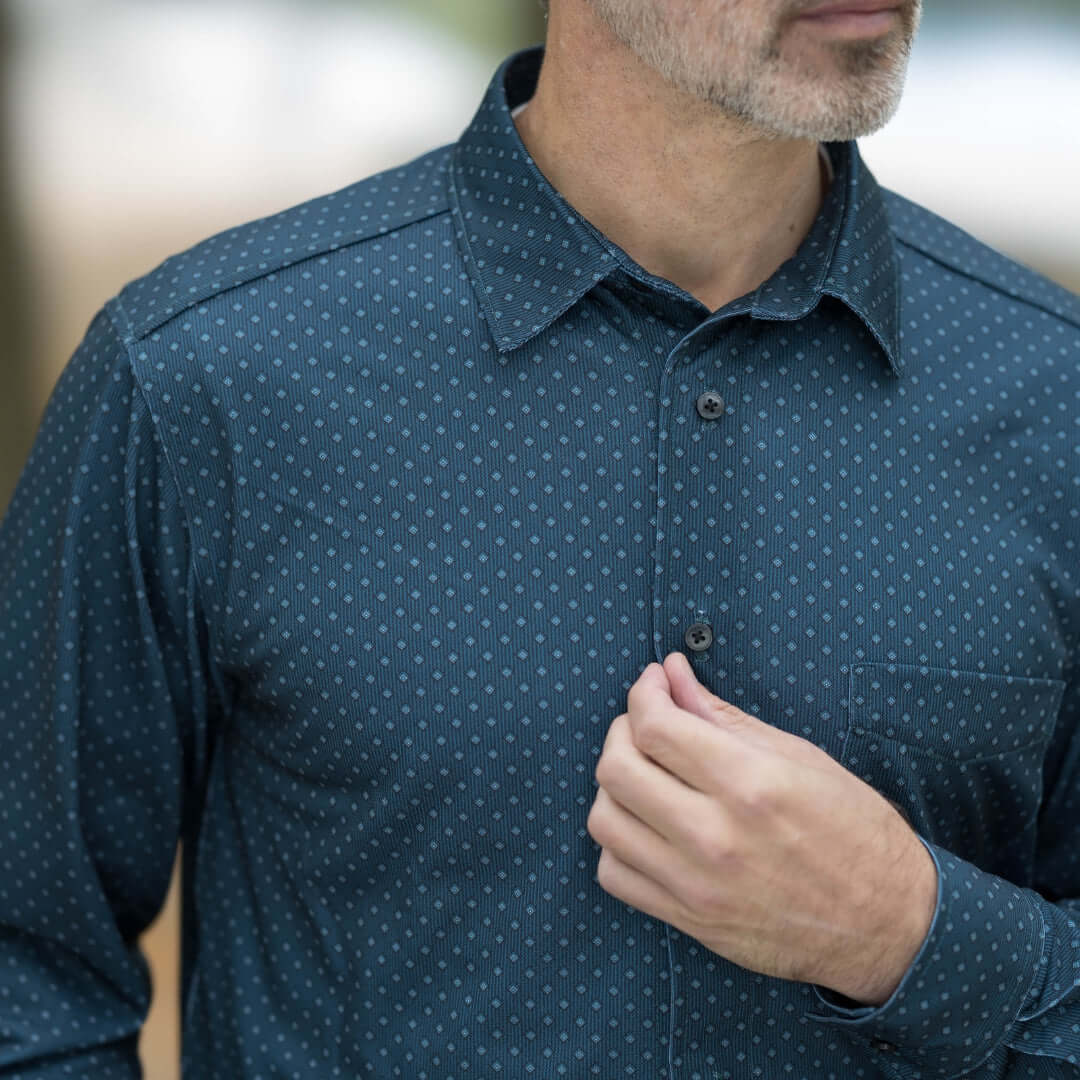 Man wearing a blue check magnetic front long sleeve shirt with pocket, showcasing comfort and style.