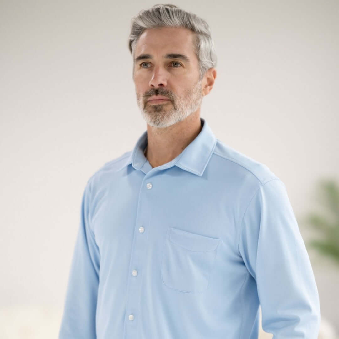 Man wearing a Carolina Blue long sleeve cooling tech shirt with pocket and magnetic buttons.